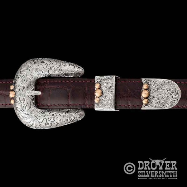 This classic Western  silver belt buckle set look will set off any outfit. Adorned with bronze beads. Shop now only at MCS!